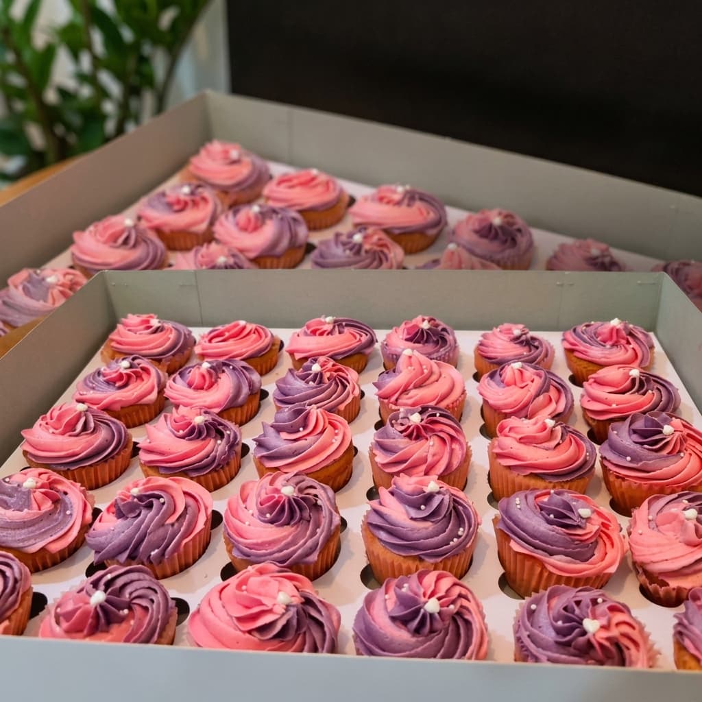 Box of pink and purple swirl cupcakes